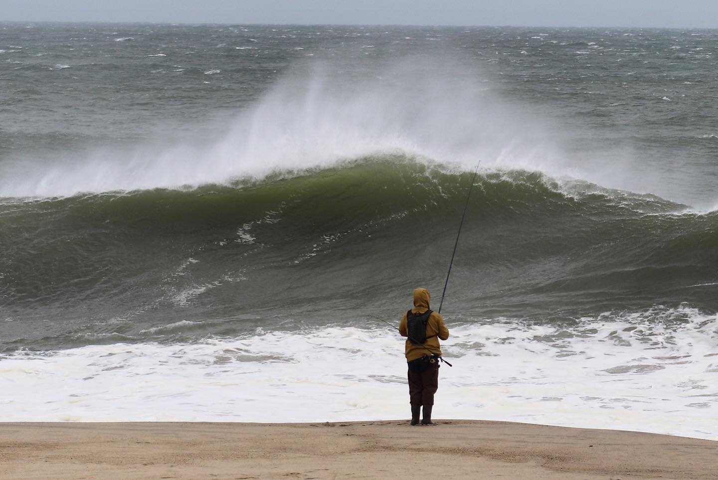 A lone fisherman checks out the high surf at Stone's Beach.