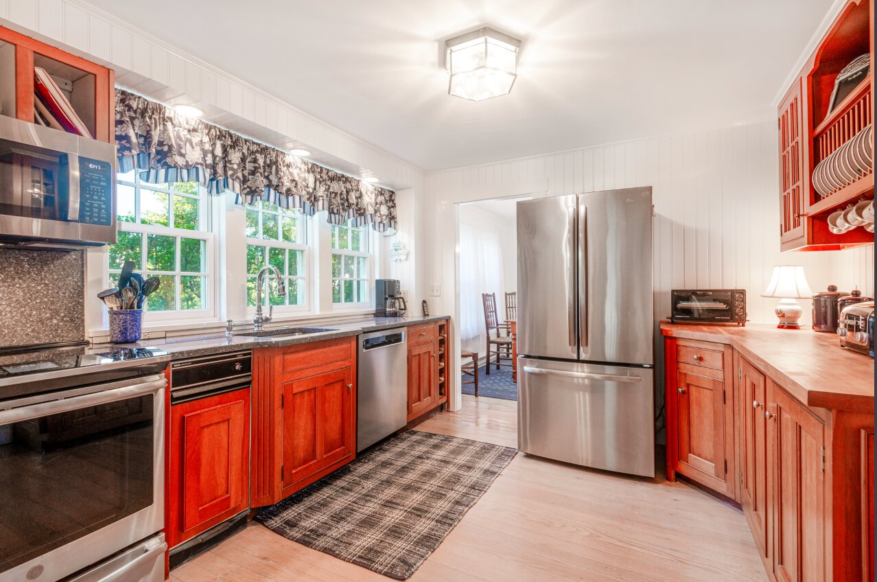 The spacious kitchen has stone- and wood-topped counters, plenty of natural light and stainless-steel appliances by GE and KitchenAid.