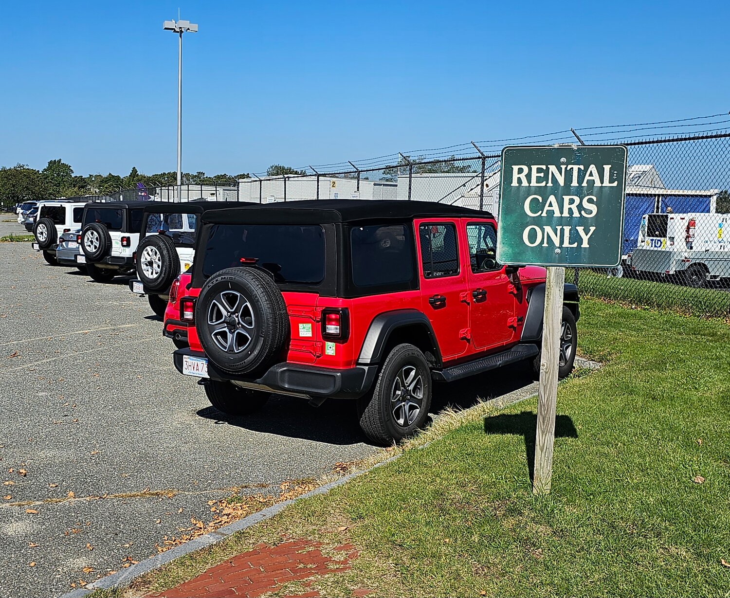 A line of rental Jeeps in the Nantucket Memorial Airport parking lot.