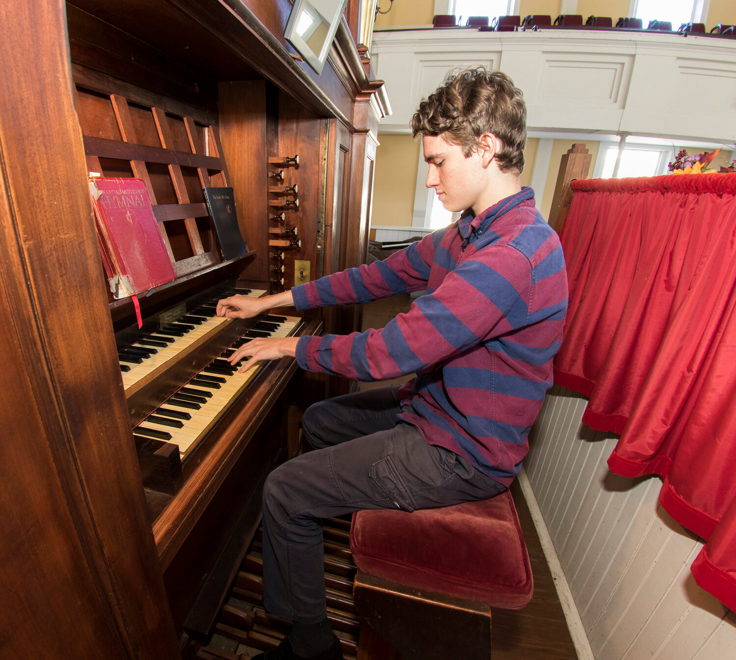 Isaiah Williams performs on the Methodist Church's 1831 Appleton organ.