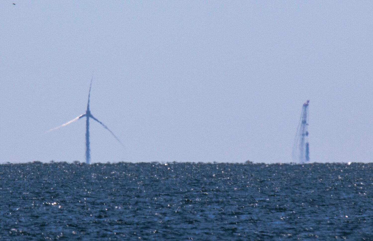 The first wind turbine installed by Vineyard Wind stands next to a construction crane. This photo was taken last week with a 600-millimeter zoom lens from the shore of Madaket Beach.