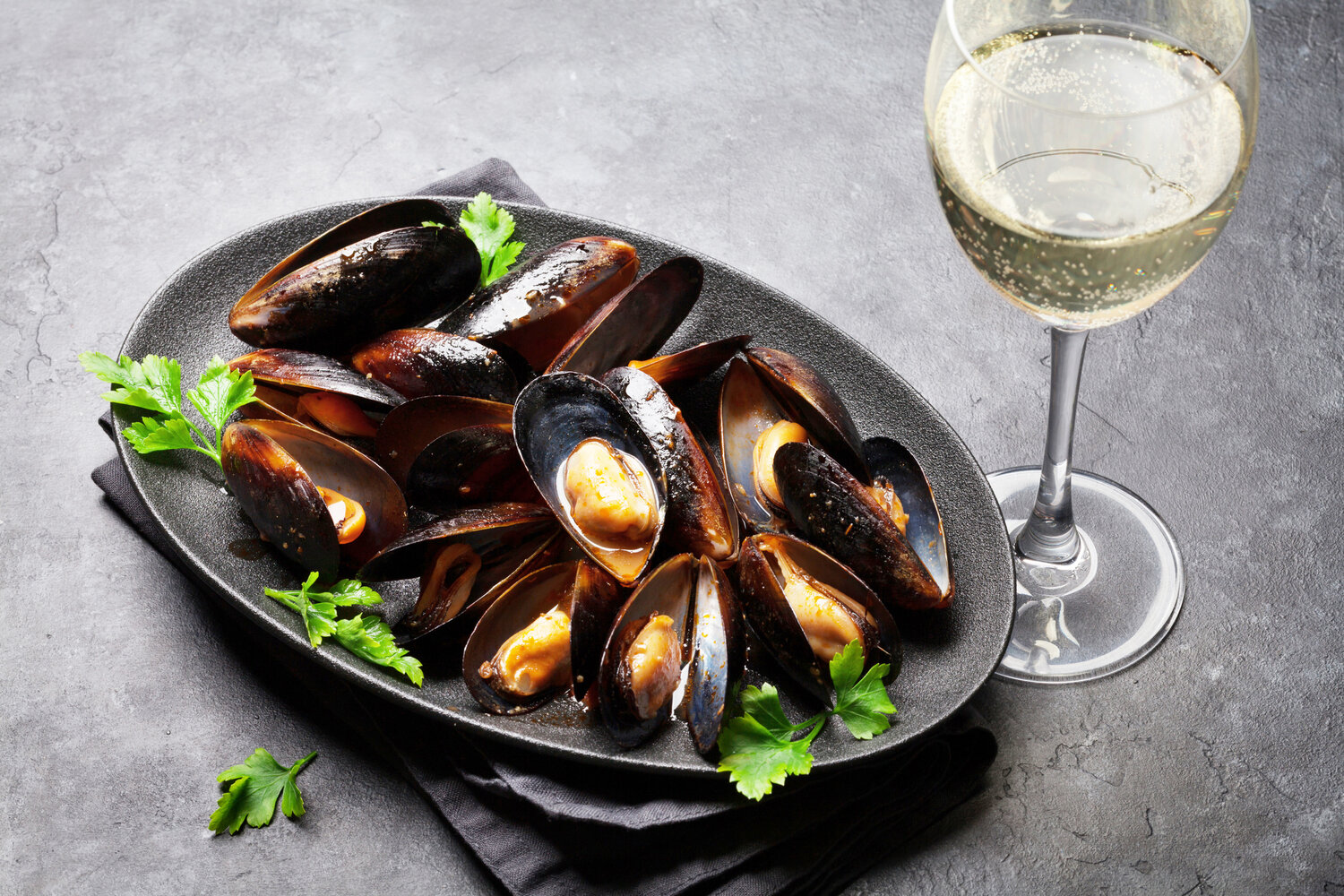 Mussels in a white wine sauce with shallots, garlic, tomato and lemon pair nicely with a New Zealand Sauvignon Blanc like Grey’s Peak.