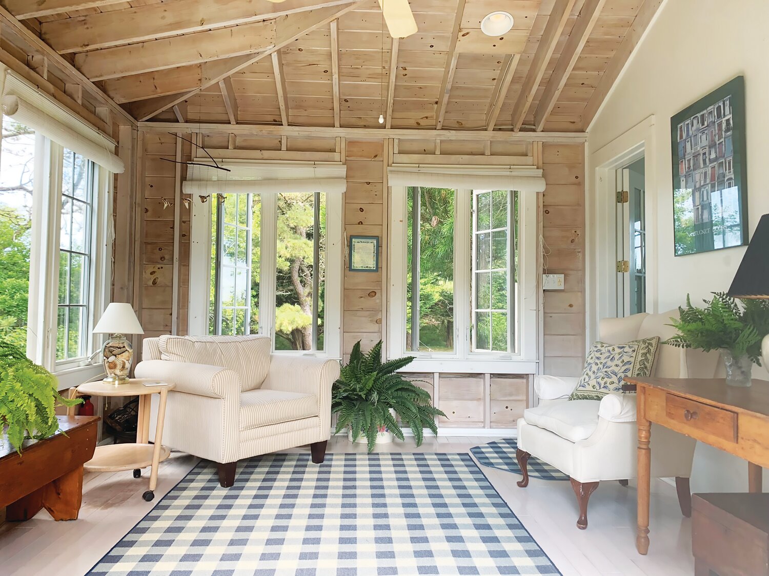 The cottage sunroom has exposed beams, a ceiling fan and is the ideal spot for relaxing three seasons of the year.