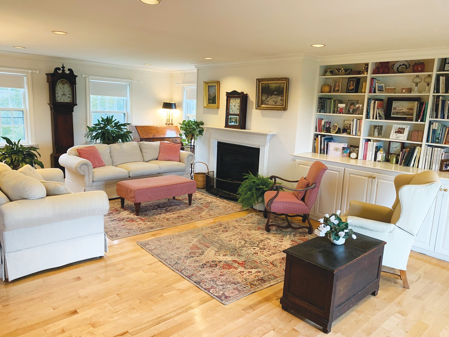 The living room has a propane fireplace, wood floors and plenty of built-in cabinetry and shelving.