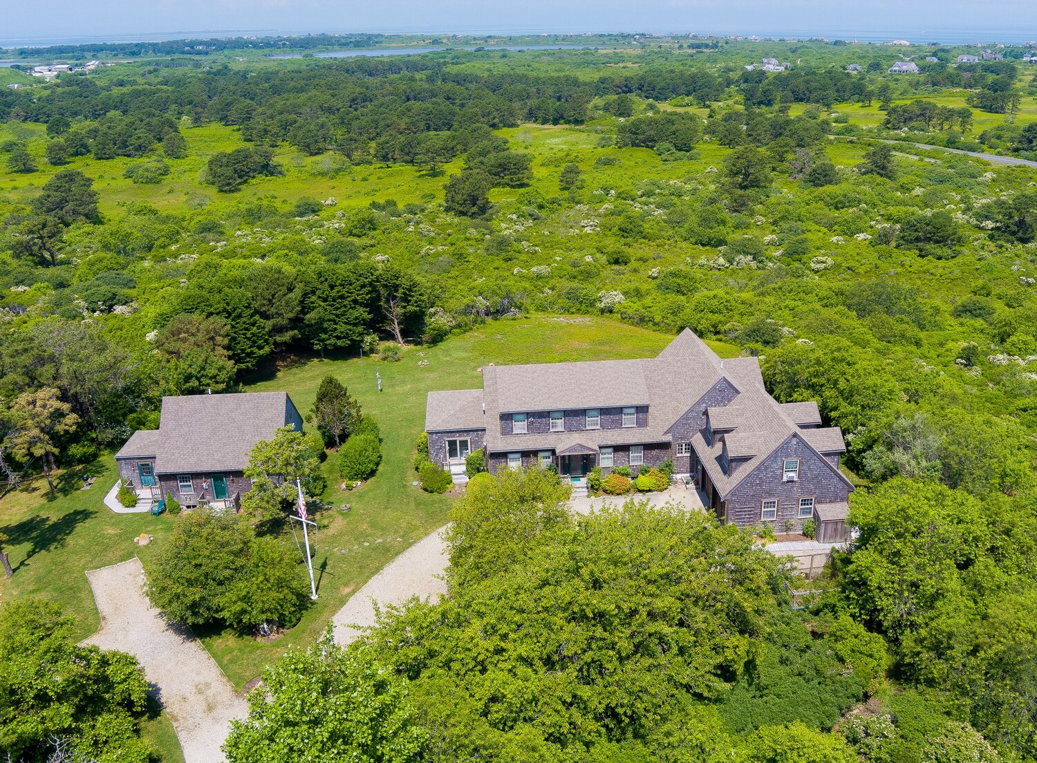 Boasting views of the north shore, picturesque sunsets and crystal-clear skies on 2.7 acres of land, this seven-bedroom, five-and-a-half-bathroom Madaket Road property includes a main house, attached two-car garage and a separate cottage.