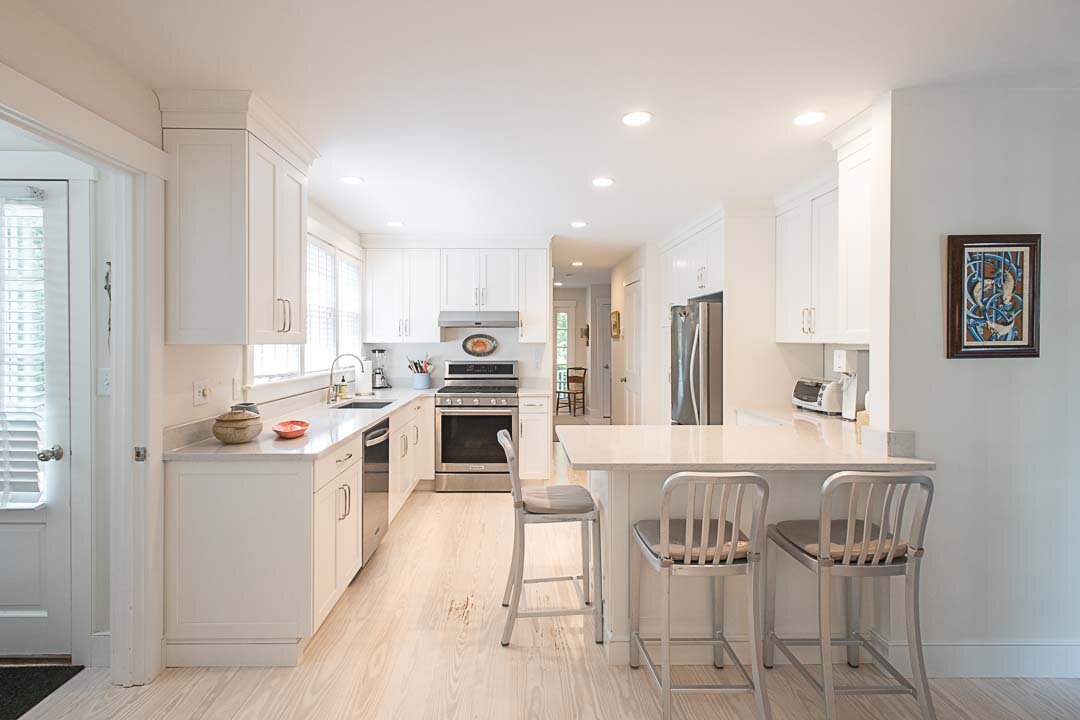 The kitchen of this Curlew Court home has attached bar-style seating, ample counter space and stainless-steel appliances including a KitchenAid stove.