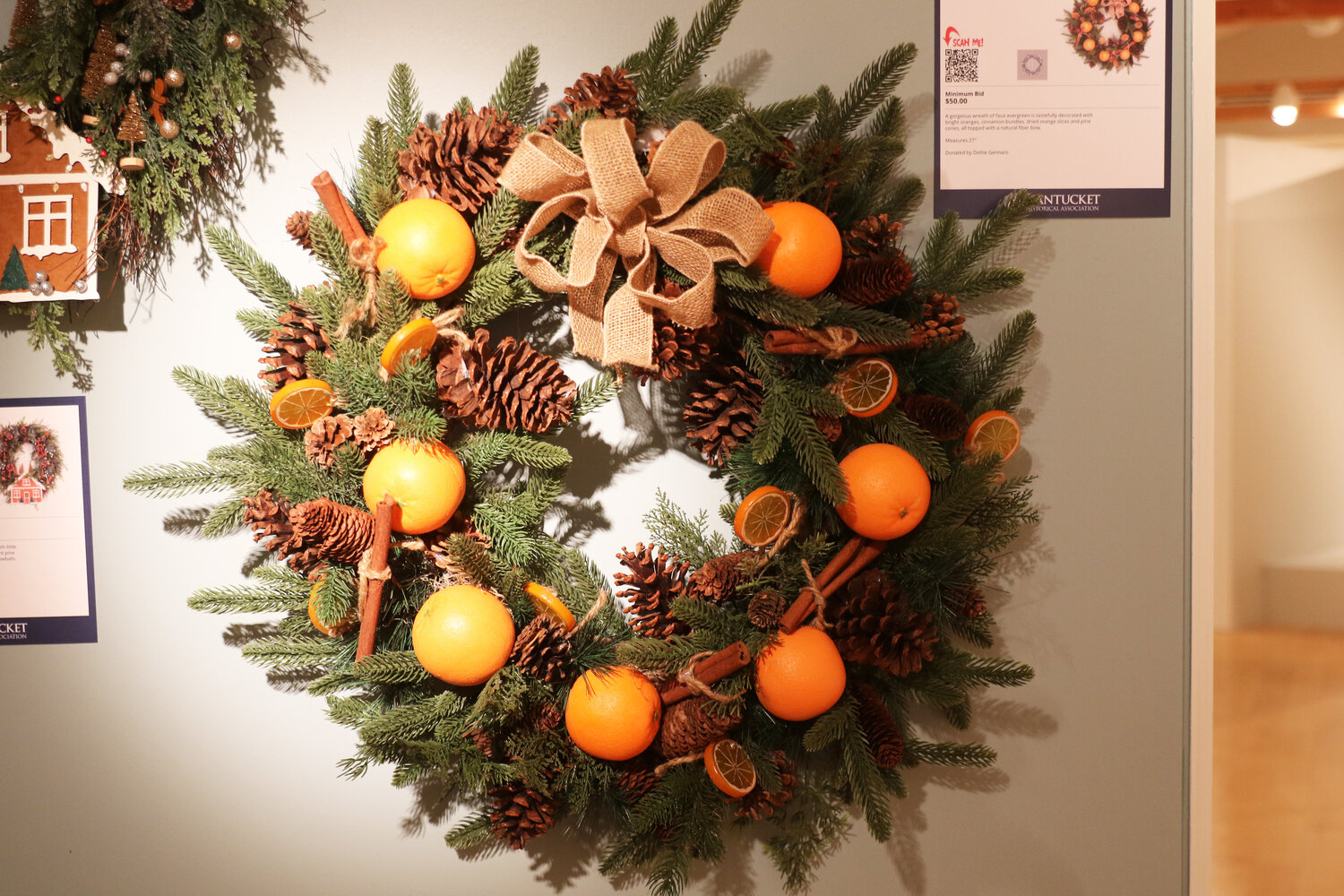 Dottie Gennaro’s wreath of pine boughs, pine cones, oranges and cinnamon sticks.