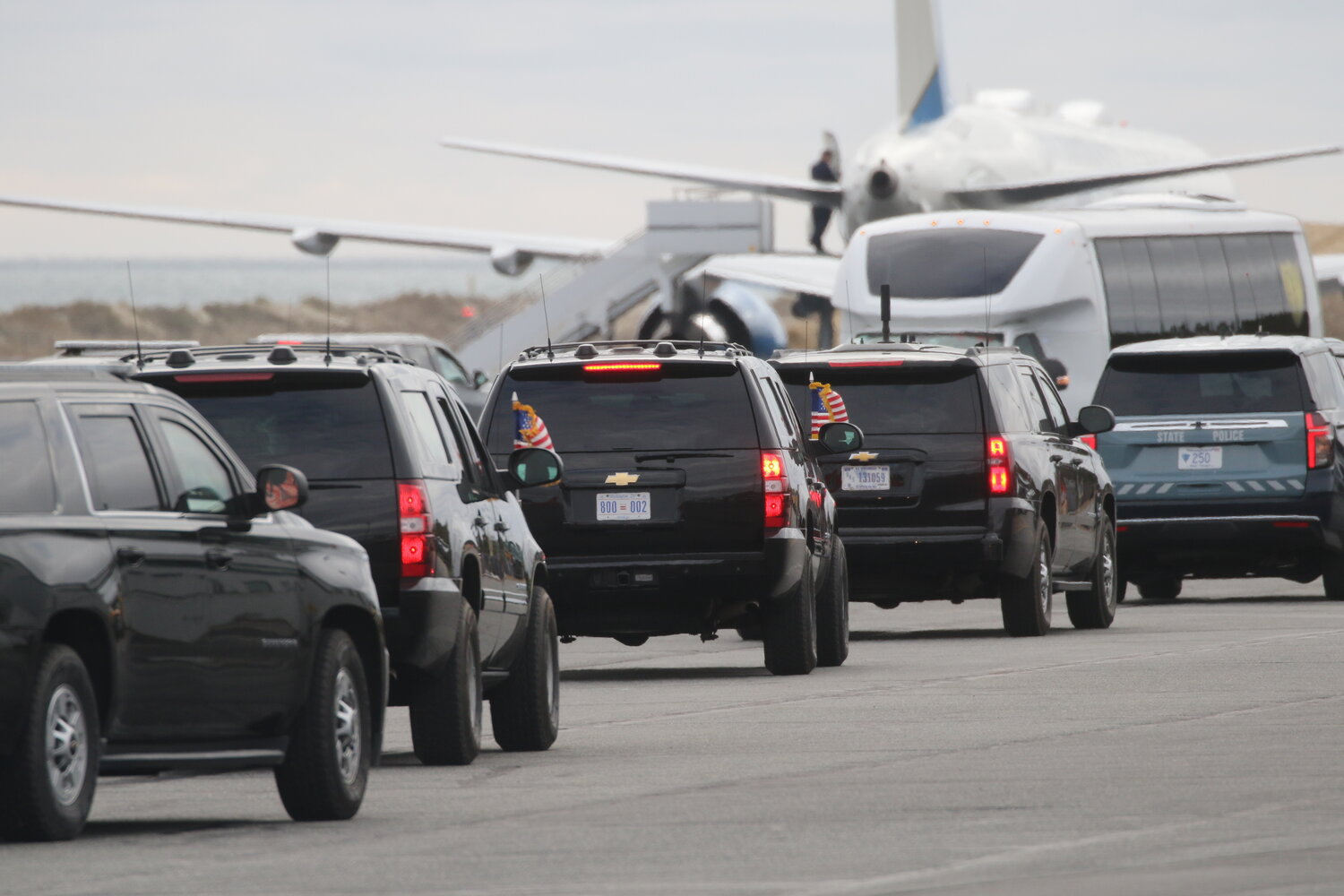 A line of government vehicles heads toward Air Force One Sunday.