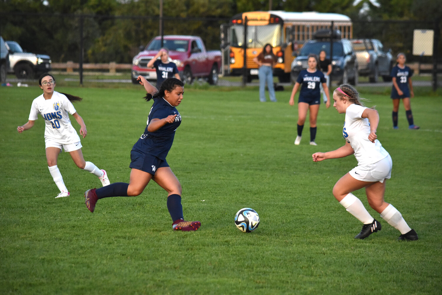 Mariana Rauda, left, and a St. John Paul II player go for a loose ball in their Sept. 21 game.