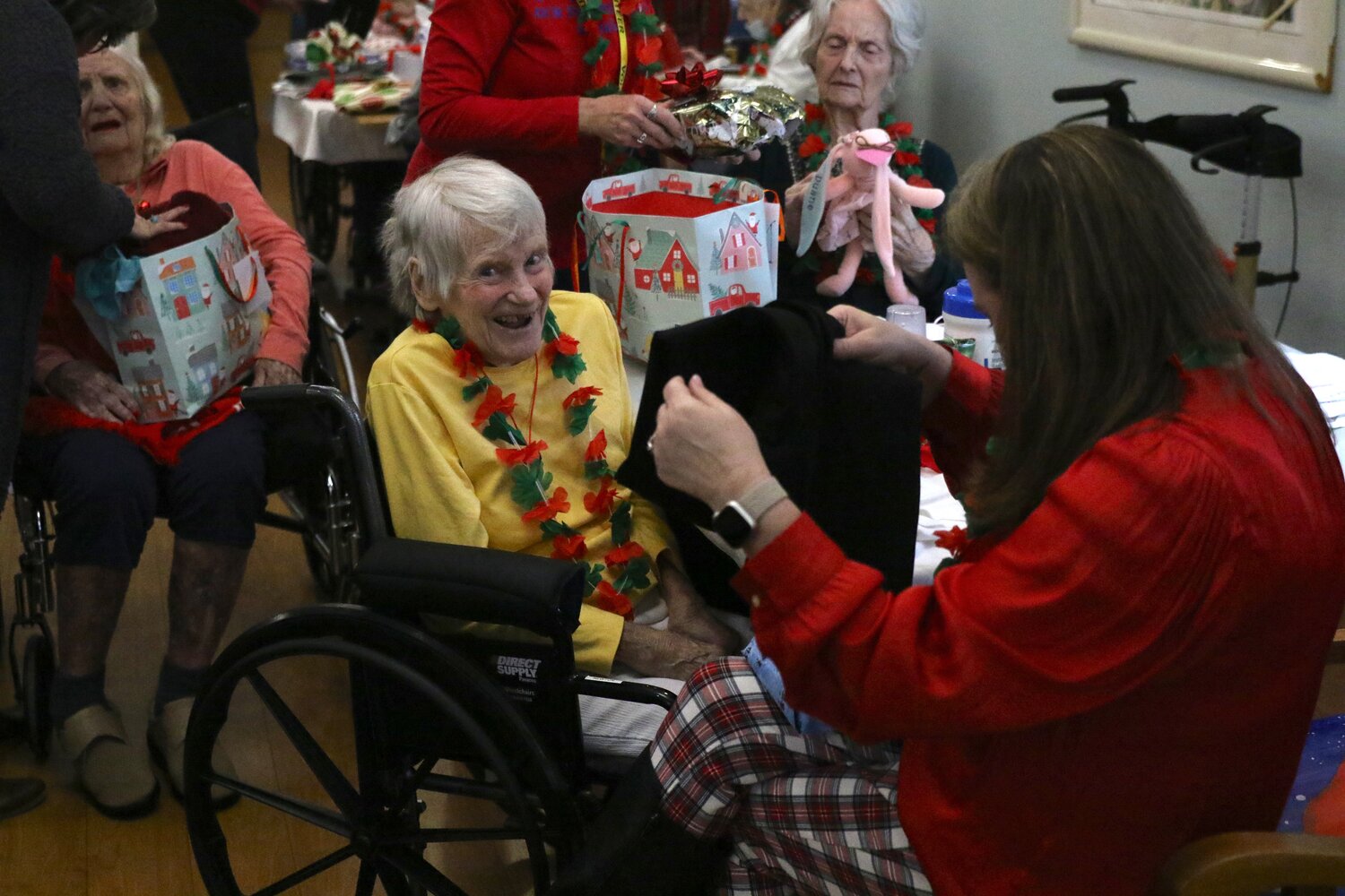 Our Island Home residents open Christmas gifts Thursday.