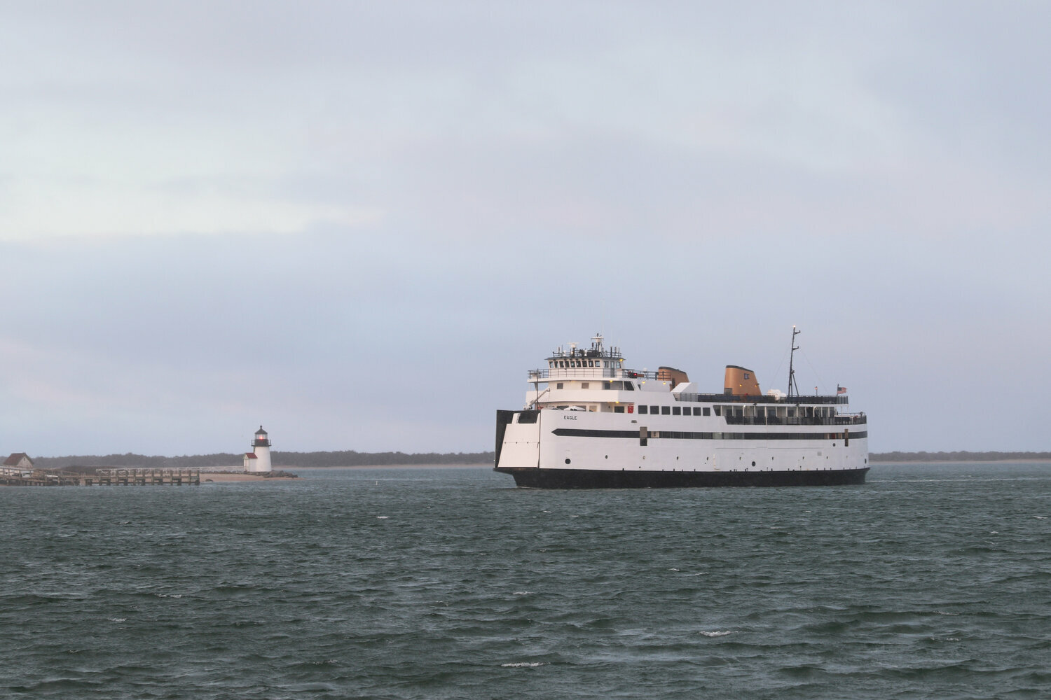The Steamship Authority’s M/V Eagle makes its way past Brant Point through an empty Nantucket harbor.