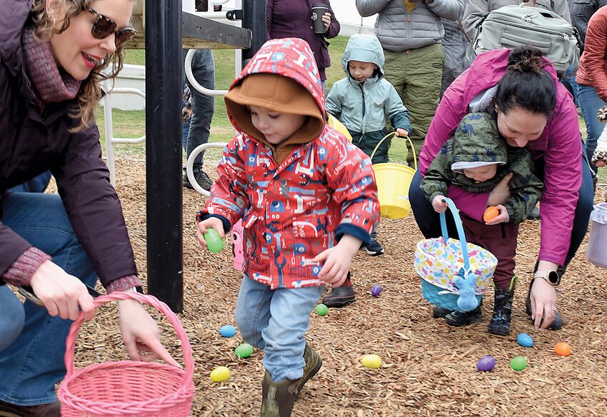 Parents assisted their young children as they gathered Easter eggs during the 42nd annual Mukilteo Firefighters Easter Egg Hunt last year at Mukilteo Elementary School.