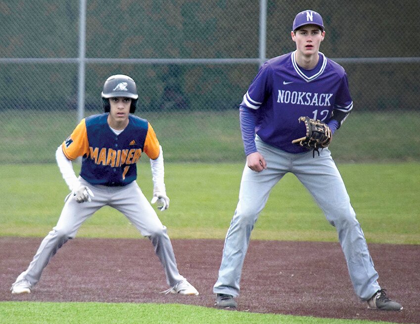 Mariner’s Trey Walker (left) takes a lead off of first base against Nooksack Valley Friday, March 8, at Mariner High School