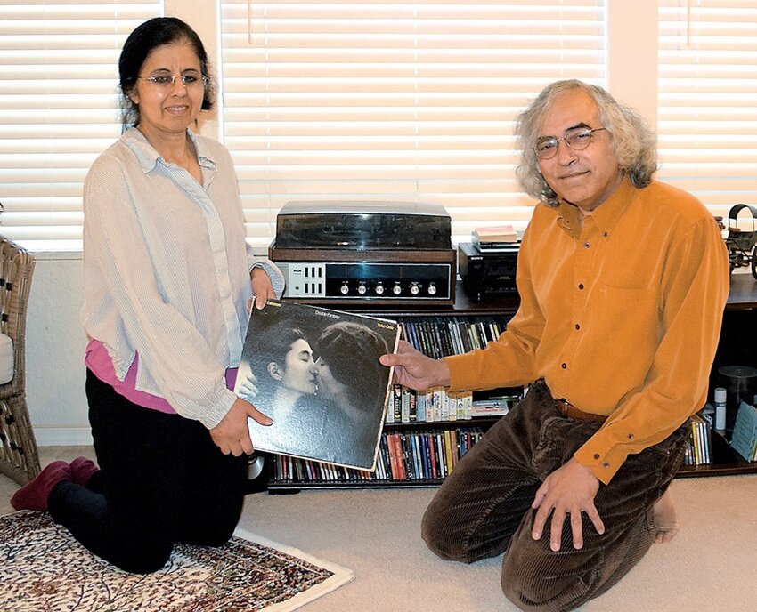 Ayesha and Vik Patnaik are producing “Dream # 9 – A Musical Play,” which attempts to answer the question of what would have happened to John Lennon if he had survived his shooting. Patnaik wrote the script and directs the play. The two are holding a copy of “Double Fantasy,” Lennon’s last album with Yoko Ono. The record player behind them is a prop in the production.