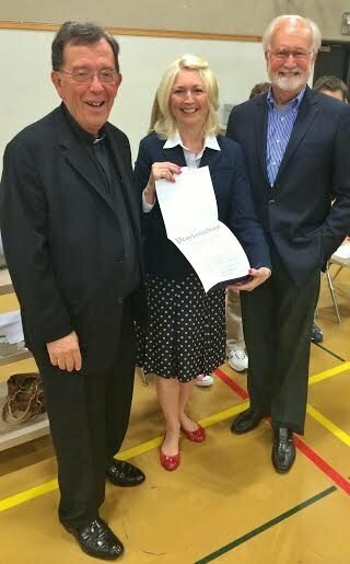 From 2014: The Rev. Kenneth Haydock and principal Sue Venable accept a proclamation from Mayor Dave Earling commemorating Holy Rosary's contributions to the community.