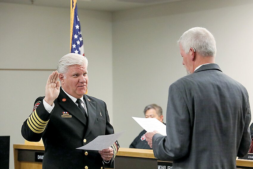 South County Fire Commissioner Ed Widdis, retired fire chief of Snohomish County Fire District 1, swears in Fire Chief Bob Eastman.