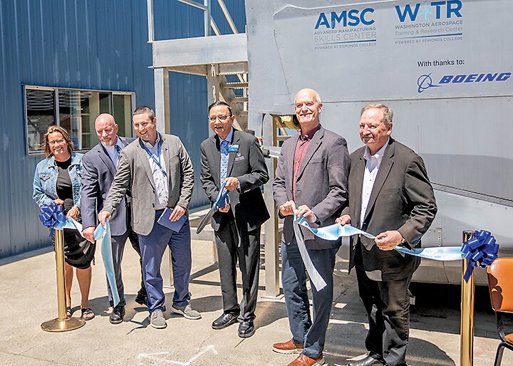 From left: Everett Mayor Cassie Franklin, AMSC Executive Director Larry Cluphf, Boeing Director of Manufacturing and Safety Cameron Myers, Edmonds College President Amit B. Singh, U.S. Rep. Rick Larsen (D-Everett), and Snohomish County Executive Dave Somers participate in a ribbon-cutting ceremony on July 2 celebrating the opening of a new fuselage training lab at Paine Field.