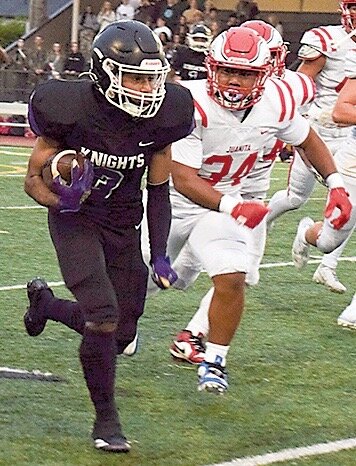 Kamiak senior wide receiver Onkar Bhangu outruns Juanita’s Isaiah Villanueva.