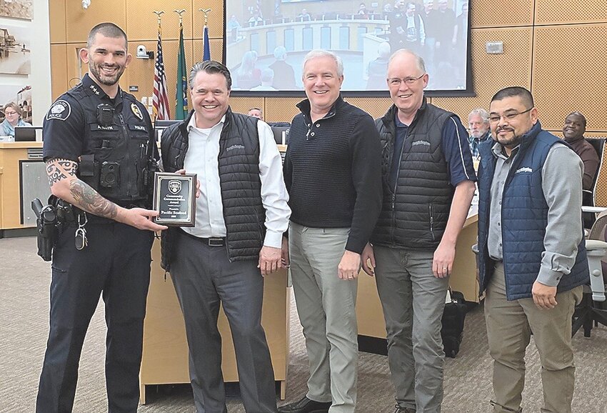 Police Chief Andy Illyn (left) and Mayor Joe Marine recognize Hannah Richmond and Steven Johannson (right) with the police department’s Community Commendation award for helping a man who suffered a medical emergency in January.