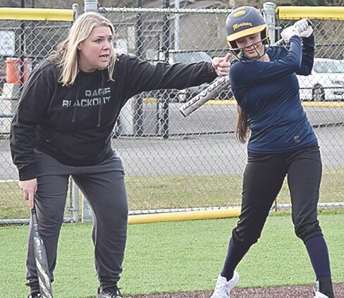 New Mariner coach Ashley Senn works with senior Estrella Urrutia.