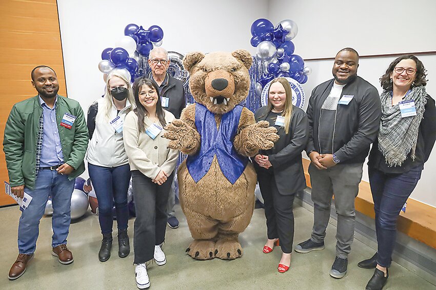 Cascadia College alumni gather with the school’s mascot during the college’s 25th anniversary celebration. (Photo courtesy Cascadia College)