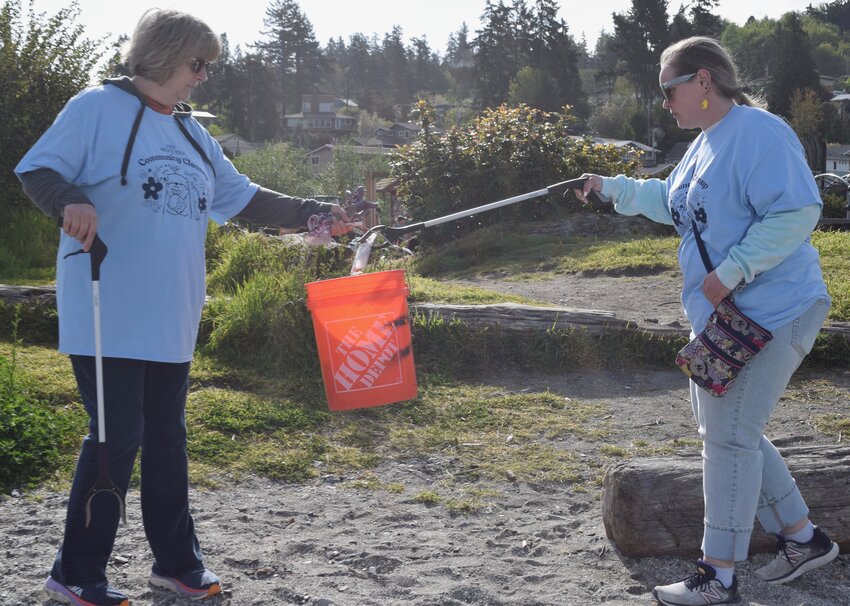 Leadership Launch executive director Adrienne Wagner and Everett Community College student Bella Anderson pull weeds.