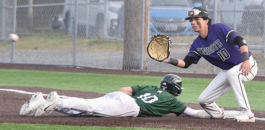 Kamiak’s Andrew Hernandez waits for a throw from the pitcher, while Skyline’s Jack Evans dives back to first base.