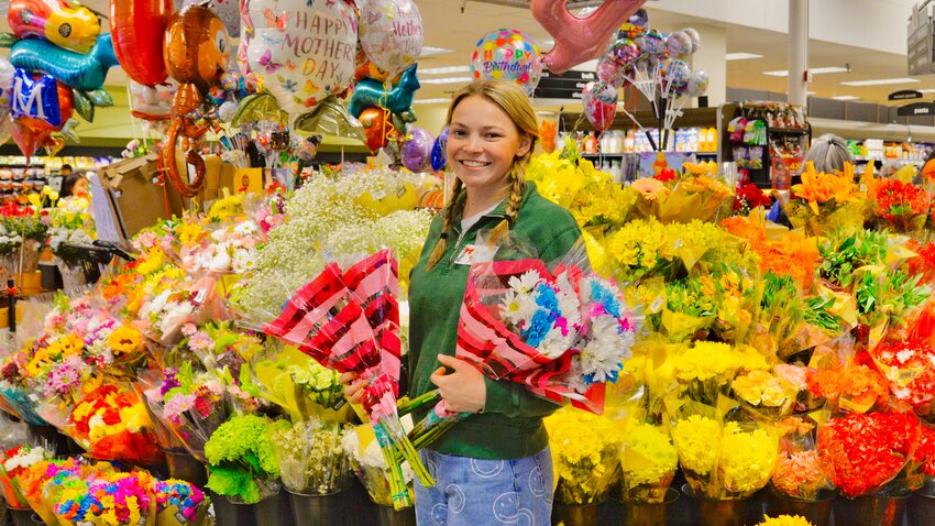 Bob Sears went to the Westgate QFC Saturday, May 10, and grabbed this photo of a very busy Jorja Fry preparing the flower display for Mother’s Day, May 11. (Photo courtesy Bob Sears)
