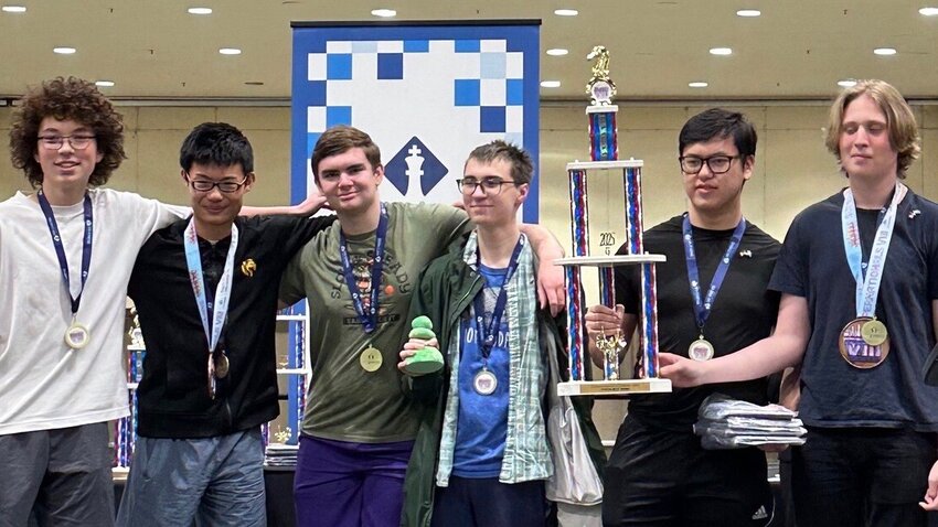 The Kamiak varsity chess team with its fourth-place trophy.