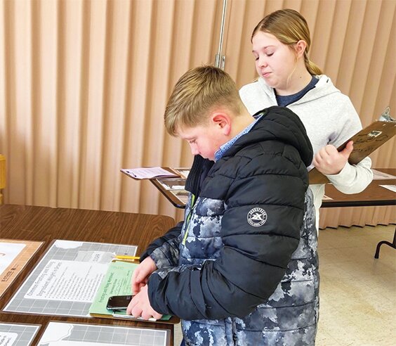 Kayley and Kenton McGuire are judging the sugar content of frosting recipes for best safety practices at the Post Rock 4-H Day Judging Extravaganza.