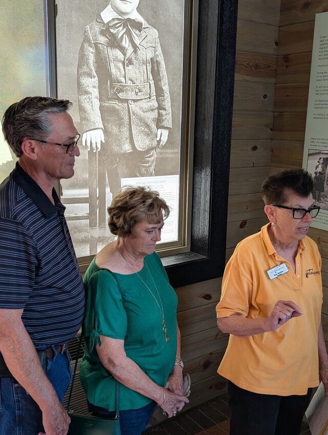 Joe and Jana Strecker with the window covering they sponsored.  Sue Sutton tells the story of Arthur Field Smith.