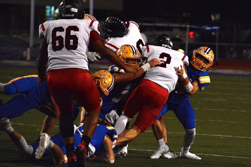 Liberators EJ Ingram and Braidyn Spiegel grab and tackle Zizzer Gabe Sellers.