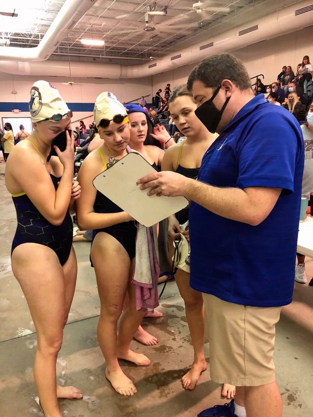 Bolivar swimmers talk strategy with coach Kyle Smith at the Ozarks Invitational swim meet on Saturday, Jan. 9.