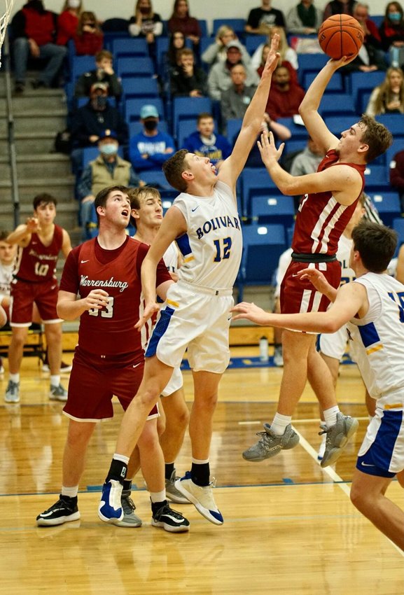 Bolivar&rsquo;s Kyle Pock, No. 12, looks to block a shot during Bolivar&rsquo;s loss to Warrensburg on Friday, Dec. 11.&nbsp;