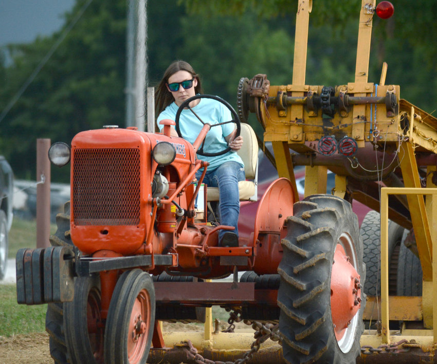 Bolivar's Cheyenne Matlock looks for a little more power during her run at the Halfway Lions Club Tractor Pull Saturday, July 14, 2018.
