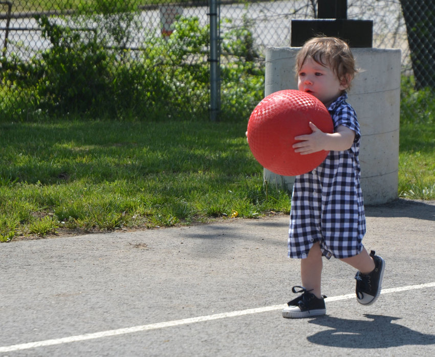 Rowen Green makes a break for it with a red ball in tow at the Communitywide Play Day at Cribbs Youth Park Saturday, May 5, 2018.