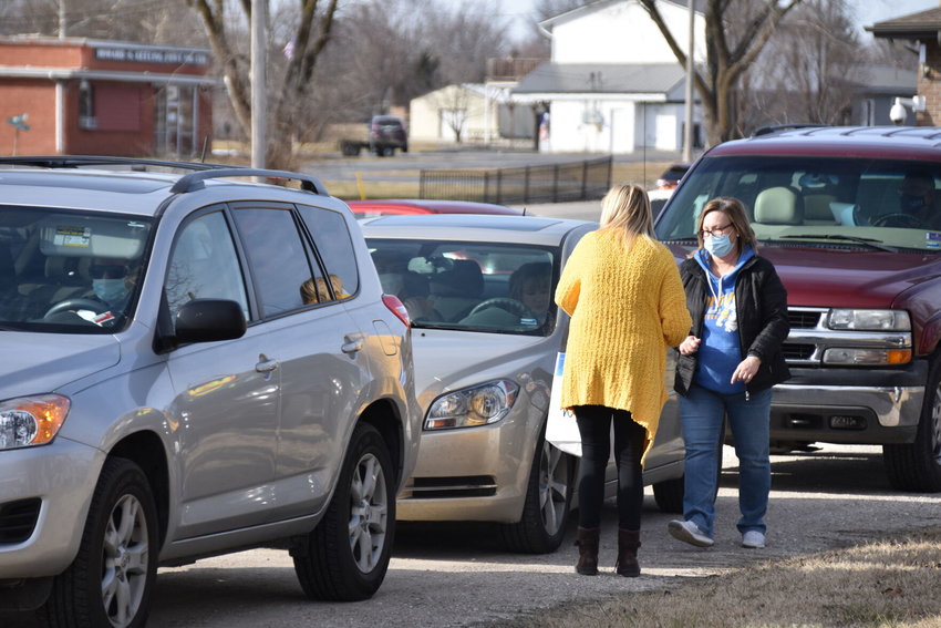 Polk County Health Center staff members work to distribute vaccines at a mass distribution event at the center&rsquo;s drive-thru facility on West Broadway Street earlier this year.&nbsp;