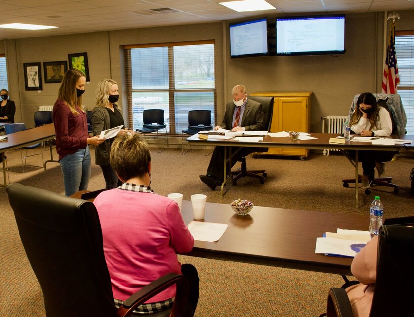 Parents Liz Burkhart and Chauntelle Murray talk with the board during its Tuesday, March 23, meeting.&nbsp;