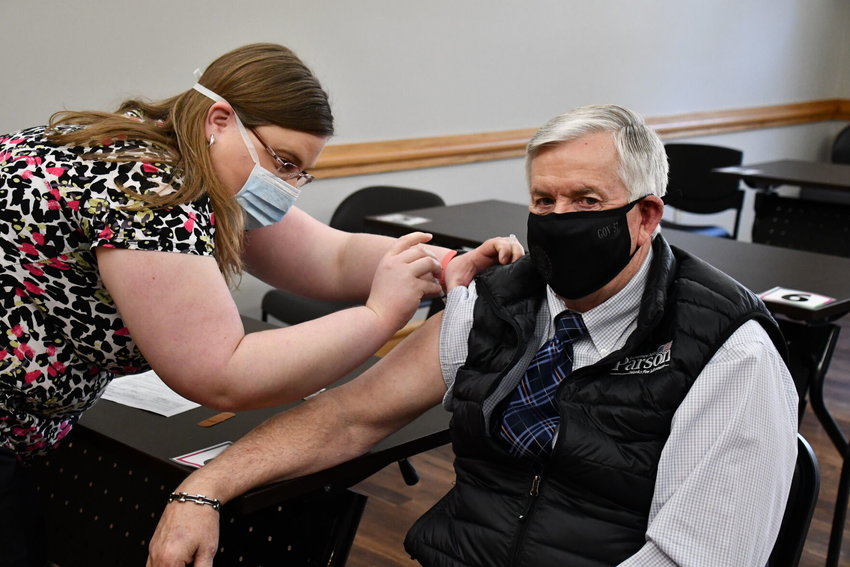 Gov. Mike Parson rolls up his sleeve for his second COVID-19 vaccination shot on Wednesday, March 3.&nbsp;