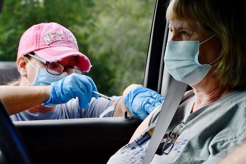 A person receives her COVID-19 vaccine at a recent drive-thru event at the Polk County Health Center.