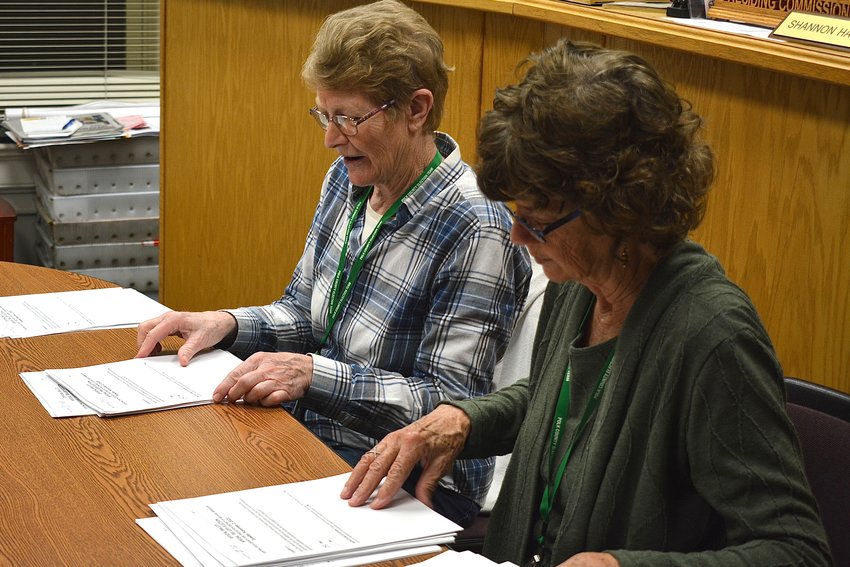 Election workers Janet Timmerman and Bonnie Potts begin the ballot counting process.