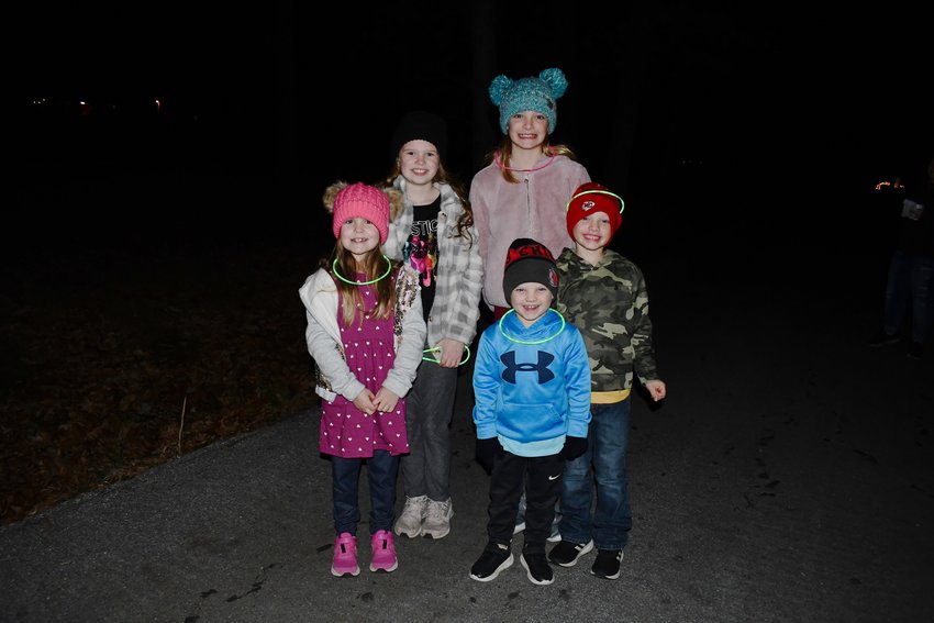 Decked out in hats, coats and glow sticks, Harper Crouch, Jace Daulton, Kelli Crouch, Lilly Daulton and Silas Daulton have fun during the annual Glow Walk on Sunday, Nov. 28.