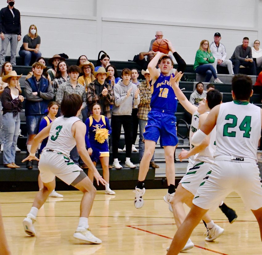 Kyle Pock goes for a 3-pointer with the Bolivar High School Super Fans cheering him on during the game Wednesday, Feb. 9.