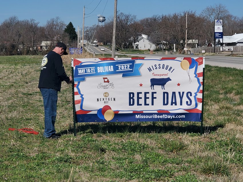 Pictured here, former Bolivar Schools superintendent Tony Berry volunteers his time to hang banners around town in advance of the big celebration.