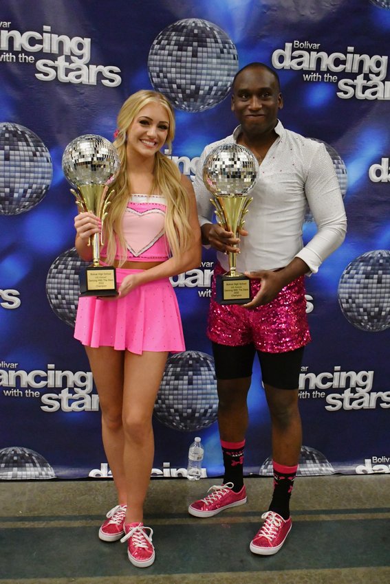 Shae Smith and Adrian Brantley pose proudly with their mirror ball trophies.