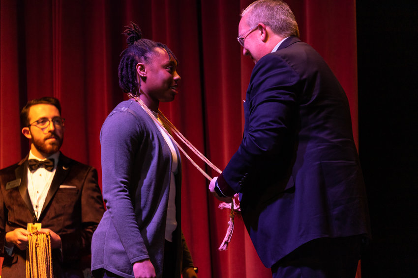 SBU president Rick Melson, right, presents honors cords to Rachel Tippens during &ldquo;A Premiere of Excellence&rdquo; academic honors ceremony, Thursday, April 7.
