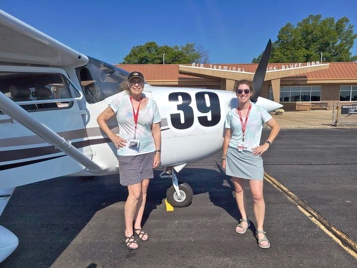 Jeann&eacute; Willerth (left) and Madeline Hooks (right) stand in front of their race plane, Charlie.