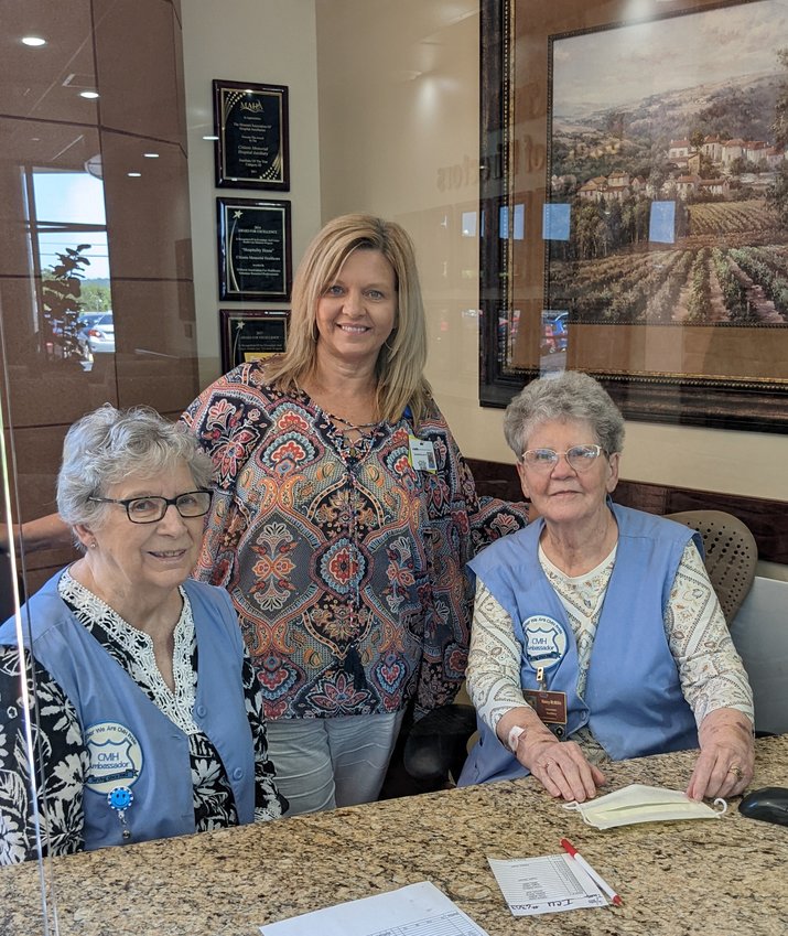 Auxiliary members assist with services at the CMH information desk.  Left to right: Donna Shelton (volunteer), Shantelle Posten (CMH Volunteer Services Director), Nancy McMillin (volunteer)