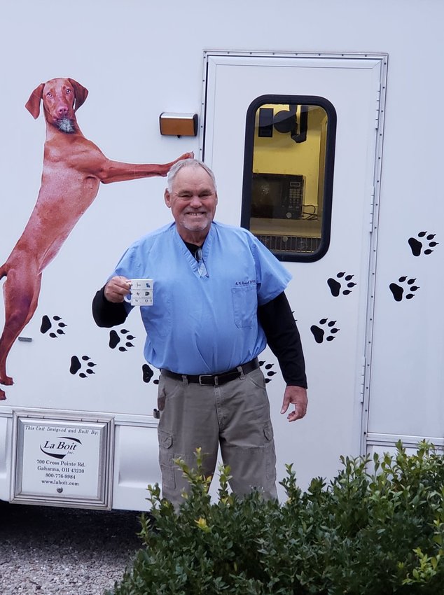 Dr. Wendell Stewart poses in front of his mobile veterinary clinic.