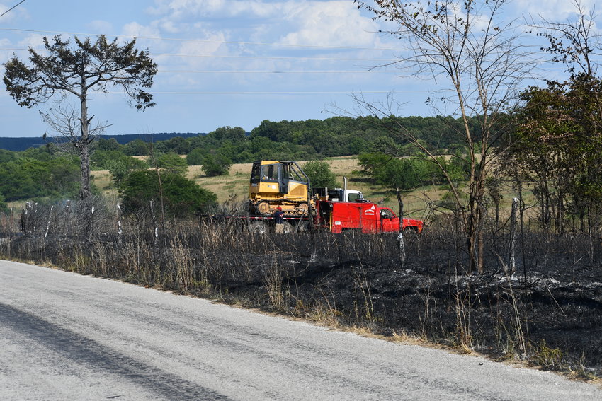 A large portion of a field and roadway were burnt in the 1600 block of East 460 Road on Tuesday July 26. Firefighters were able to get the ground fire under control before any structural damage occurred.